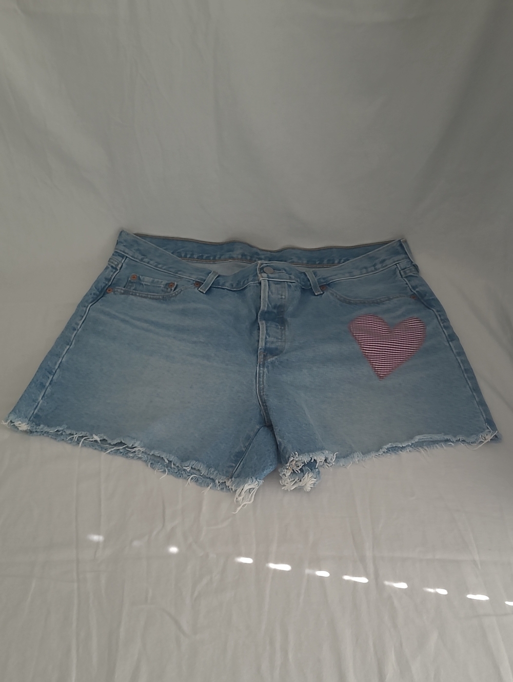 Levi's Faded Blue Denim Shorts with Dark Red Heart Patch